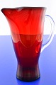 Holmegaard 
glass works. 
Nice red glass 
jug and clear 
glass handle, 
height 21 cm.  
90.0 cl. No ...