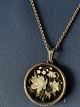Beautiful 
silver chain 
with pendant. 
The pendant has 
an inlaid 
floral motif. 
The pendant's 
...