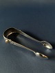 Beautiful and antique sugar tongs, made with nice details and 2 pieces of amber inlaid in the ...
