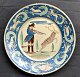 Brack, Carl 
Vilhelm (1894 - 
) : Circular 
dish of glazed 
earthenware 
with hunting 
scene. The fan 
...
