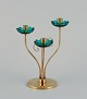 Gunnar Ander 
for Ystad 
Metall, Sweden. 
Brass 
candlestick 
holder with 
turquoise glass 
sleeves. ...