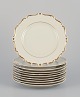 KPM, Poland. A 
set of ten 
cream-colored 
porcelain 
plates with 
gold ...