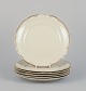 KPM, Poland. A 
set of six 
porcelain lunch 
plates.
Cream-colored 
with gold rim 
...