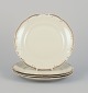 KPM, Poland. A 
set of four 
porcelain lunch 
plates.
Cream-colored 
with gold rim 
...