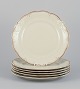 KPM, Poland. A 
set of six 
dinner plates 
in 
cream-colored 
porcelain.
Decorated with 
a gold ...