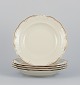 KPM, Poland. A 
set of five 
large deep 
porcelain 
plates in cream 
color.
Gold-rim ...