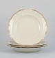 KPM, Poland. A 
set of four 
large deep 
porcelain 
plates in cream 
color.
Gold-rim ...