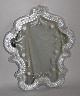 Venetian mirror, Italy, 20th century. Mirror glass with grindings, rim made with rocailles and ...