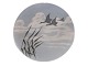Royal Copenhagen Art Nouveau plate decorated with flying swans.The factory mark tells, that ...