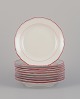 Meissen, 
Germany. A set 
of ten plates. 
Decorated with 
coral red and 
gold-colored 
trim. Art ...