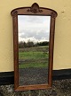 Large mirror in a fine wooden frame. Height: 125 cm, width 63 cm. Has previously been mounted ...