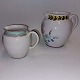 Two hand-painted ceramic jugs. The large one for water or milk, the small one for cream. Both ...