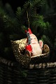 Old Christmas 
tree decoration 
in the form of 
Santa Claus in 
a gold sleigh. 
Made of 
cardboard ...