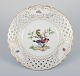 Meissen, 
Germany. Open 
lace porcelain 
plate. 
Hand-painted 
with a bird 
motif and 
insects, gold 
...