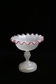 Fine old 
confectionary 
glass bowl on a 
foot in white 
opal glass 
with a wavy 
edge, decorated 
...
