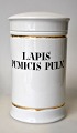 Apothecary jar 
in porcelain. 
19th century 
White porcelain 
with two gilt 
edges. Black 
text "LAPIS ...