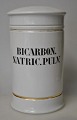 Apothecary jar 
in porcelain. 
19th century 
White porcelain 
with two gilt 
edges. Black 
text ...