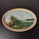 Painting on oval plate. Painted landscape motif on terracotta plate from Peter Ipsen, ...
