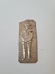 Votive in silver with motif of a boy Stamped 800Dimension 3.5 x 8 cm.