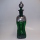 Dansk 
klukflaske i 
grønt glas fra 
Holmegaard 
Glasværk Ca. 
1920. På 
skuldre og prop 
tinmontering 
...