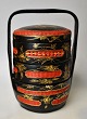 Chinese food 
container in 
wicker work, 
20th century. 
Red and black 
painted. With 
gilded ...