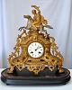 French mantel 
clock in gilded 
zinc, 19th 
century France. 
Decoration of 
riding man. 
Clock housing 
...