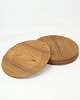 The teak plates 
from the 1960s 
are a charming 
manifestation 
of the 
mid-century 
modern 
aesthetic. ...