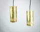 The brass 
ceiling lamp, 
characterized 
by a 
characteristic 
cylinder shape 
and a black 
cord, is a ...
