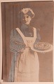 Postcard: 
"Happy New 
Year"" Woman 
with two cakes. 
In each arm. 
Canceled 
AALBORG in 
1910. In good 
...