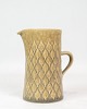 The milk jug from Bing & Grøndahl, designed by Jens Quistgaard as part of the Relief series, is ...