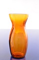 Amber hyacinth 
glass oval base 
and round 
opening, blown 
in striped 
optics, Height 
14.5 cm. ...