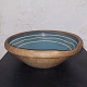 Old bowl in pottery.  Blue glaze inside with decorative light stripes. Age-related signs of wear ...