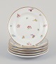 Six small 
porcelain 
plates. 
Hand-painted 
with polychrome 
floral motifs 
and gold rims. 
Porcelain ...