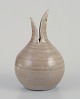 European studio 
ceramicist. 
Round vase with 
a two-part 
neck.
Glazed in 
light brown 
tones with ...