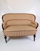 This antique 
two-seater sofa 
from approx. 
1890 is a fine 
example of 
period 
craftsmanship 
and ...