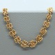 A. F. 
Rasmussen; A 
wide necklace 
of 14k gold, l. 
42 cm.