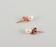 Swedish 
goldsmith. A 
pair of classic 
ear studs in 18 
karat gold 
adorned with 
cultured ...