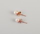 Swedish 
goldsmith. A 
pair of classic 
ear studs in 18 
karat gold 
adorned with 
cultured ...