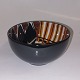 Faience bowl 
from Royal 
Copenhagen. 
Colorful 
decoration 
inside. black 
on the outside. 
Designed ...