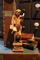 Old figure in carved wood of a real "Bookworm", a man who stands engrossed and 
holds a lot of books...