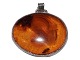Oval-shaped amber pendant with silver mounting