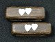 A set of moss 
oak napkin 
rings with 
silver inlays, 
1956, Denmark. 
With two hearts 
and the date: 
...
