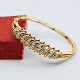 Gold bangle in 
18k gold set 
with diamonds 
mounted in 
white gold. 
The bracelet 
can be opened. 
...