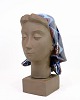 Ceramic figure 
with a motif of 
a woman's head 
with a scarf, 
model No. 
159/2897 made 
with ...