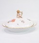 Large Lid Dish 
decorated with 
a "Putti" 
sitting on the 
lid made of 
Royal porcelain 
with ...
