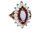 14 ct. gold 
cocktail ring 
(cluster ring) 
with one large 
and many 
smaller opals 
and rubies.
A ...