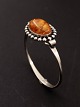 N.E.From 
sterling silver 
vintage bangle 
5.4 x 5 cm. 
with amber 
subject no. 
588413
