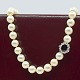 Hartmann's; 
Pearl necklace 
strung with 
knots between 
the pearls, set 
with a 18k 
white gold ...