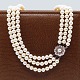 A pearl necklace with 14k white gold clasp set with rubies