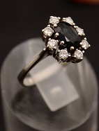 14 carat white gold ring  with sapphire surrounded by diamonds